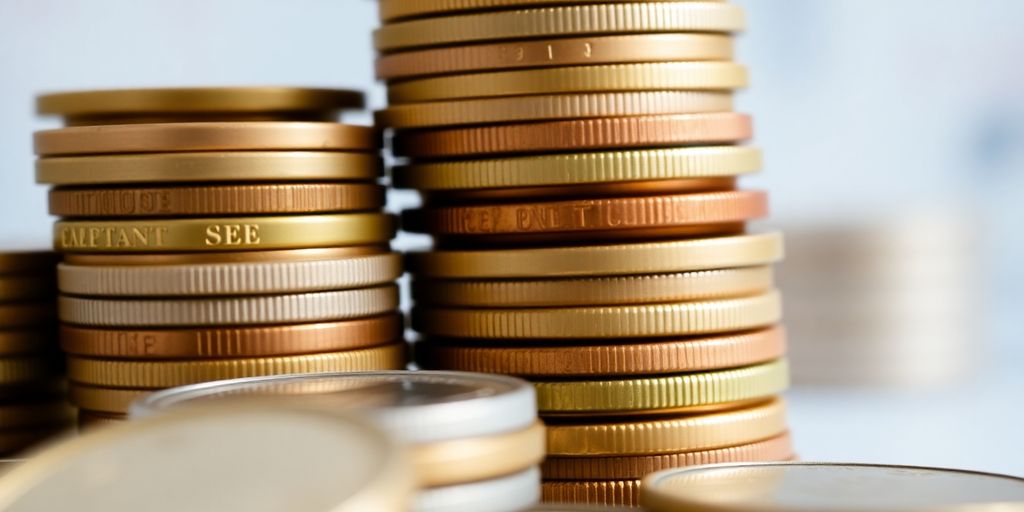 Close-up of stacked coins with varying sizes and colors.